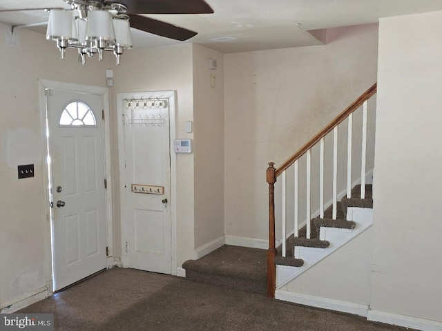 carpeted entryway with stairway and baseboards