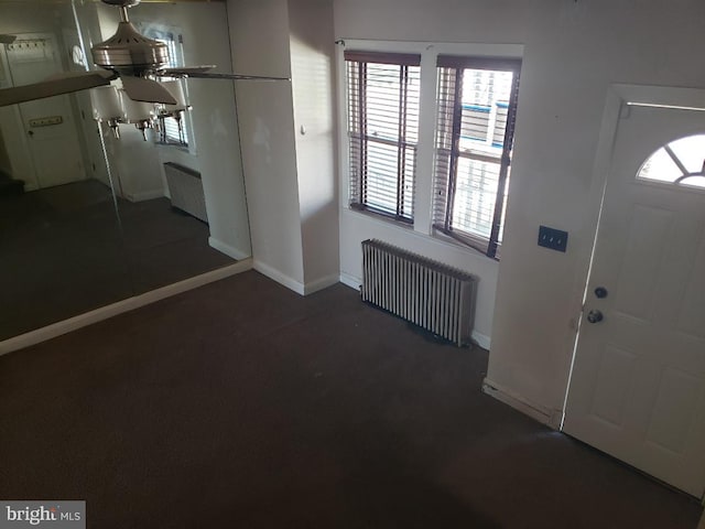 foyer with radiator heating unit and baseboards