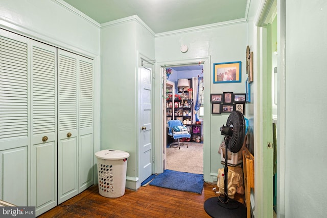 corridor with dark wood-style floors and crown molding