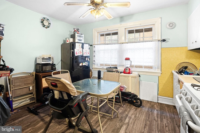 dining area with a healthy amount of sunlight, dark wood-style flooring, and ceiling fan