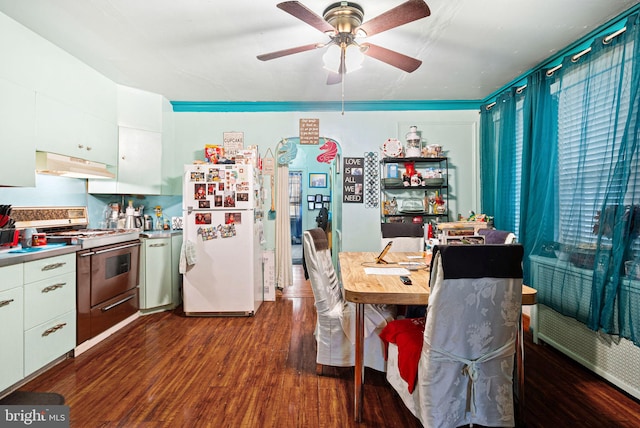 kitchen featuring dark wood-style floors, freestanding refrigerator, white cabinets, under cabinet range hood, and high end stainless steel range