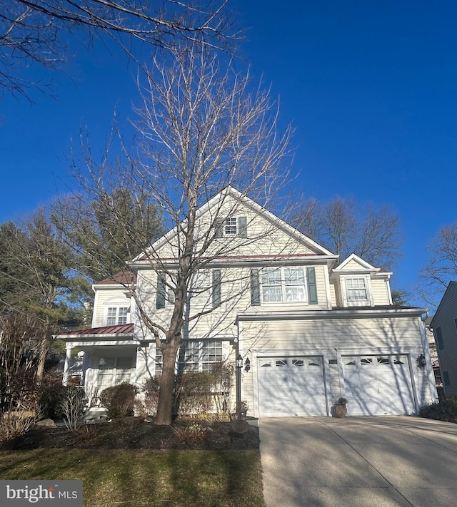 view of front facade with concrete driveway and a garage