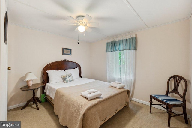 bedroom with baseboards, light carpet, a ceiling fan, and crown molding