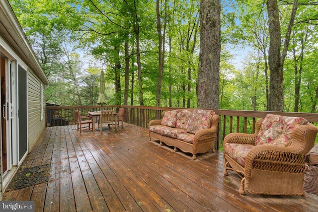 wooden terrace with outdoor dining space