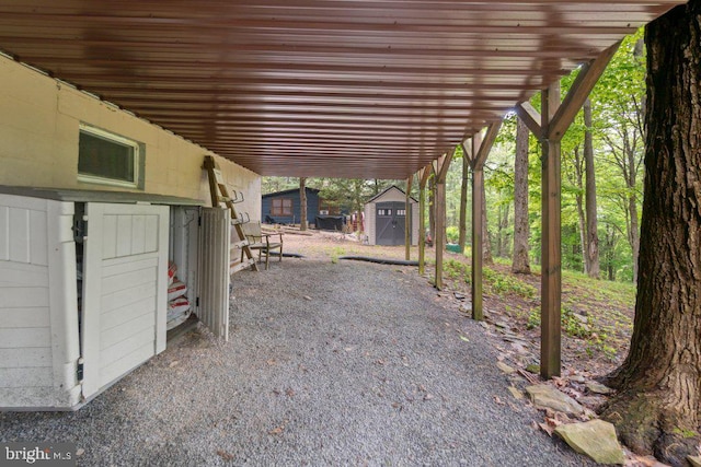 view of patio featuring a storage unit and an outdoor structure