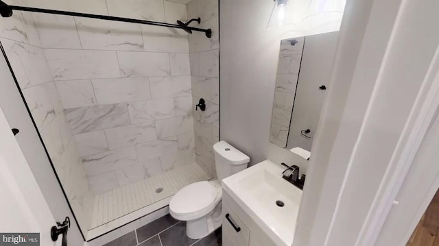 full bathroom with toilet, a stall shower, and vanity