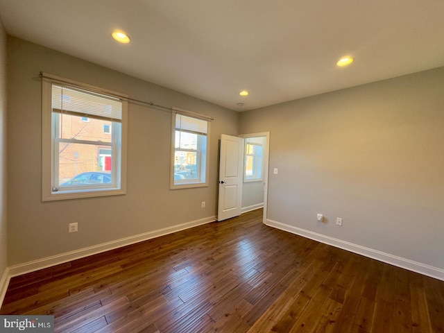 unfurnished room featuring recessed lighting, baseboards, and dark wood-style flooring