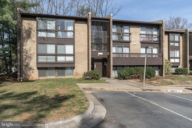 view of building exterior featuring uncovered parking