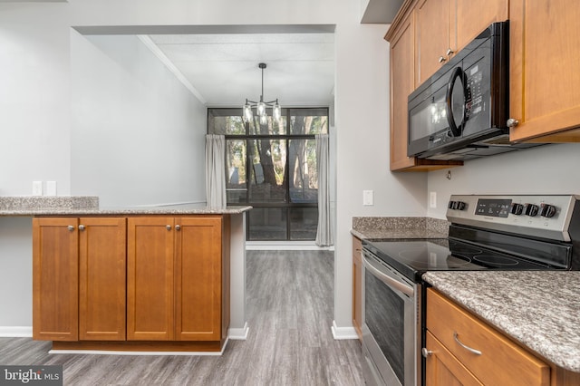 kitchen with stainless steel range with electric stovetop, light wood finished floors, brown cabinetry, and black microwave