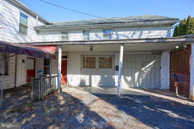 view of property featuring roof with shingles