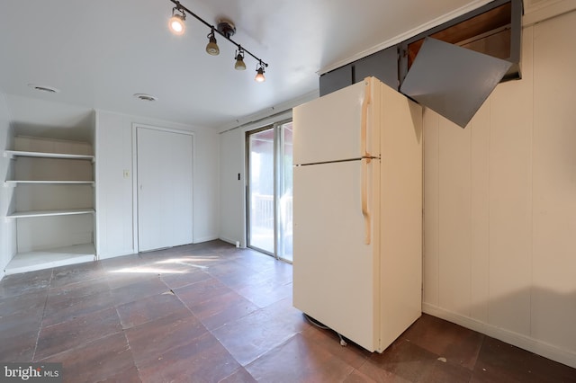 kitchen featuring track lighting and freestanding refrigerator