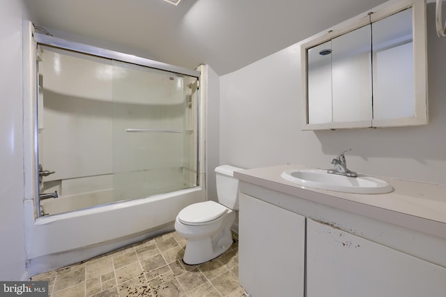 full bath featuring shower / bath combination with glass door, stone finish flooring, toilet, and vanity