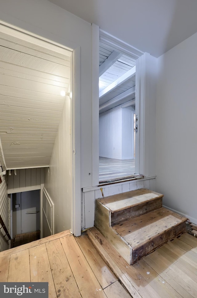 staircase with hardwood / wood-style flooring