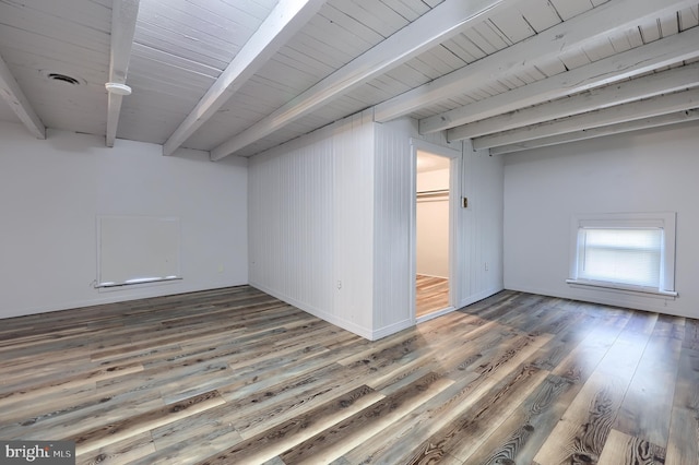 basement with visible vents, wood ceiling, and wood finished floors