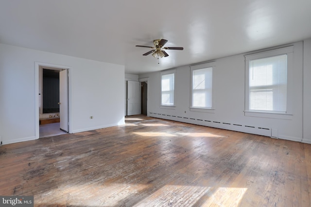 empty room with baseboard heating, ceiling fan, baseboards, and hardwood / wood-style floors