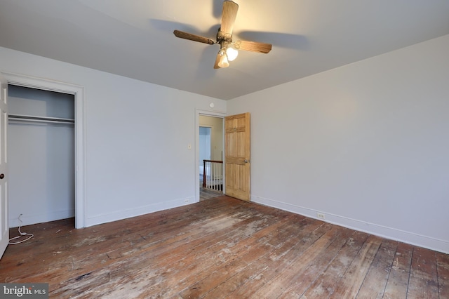 unfurnished bedroom with a closet, baseboards, a ceiling fan, and hardwood / wood-style flooring