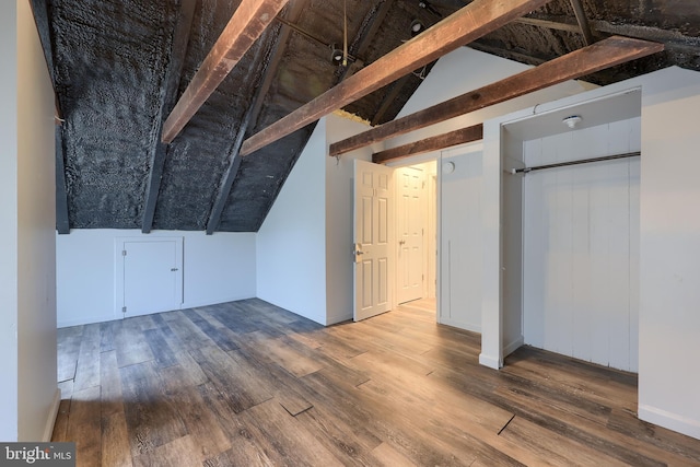 bonus room with vaulted ceiling with beams and wood finished floors