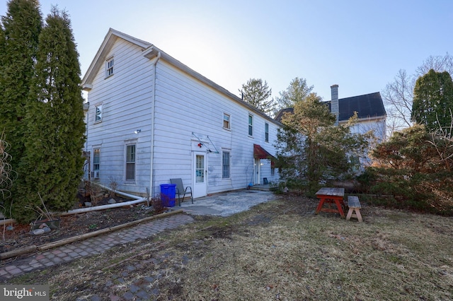 back of house with a patio