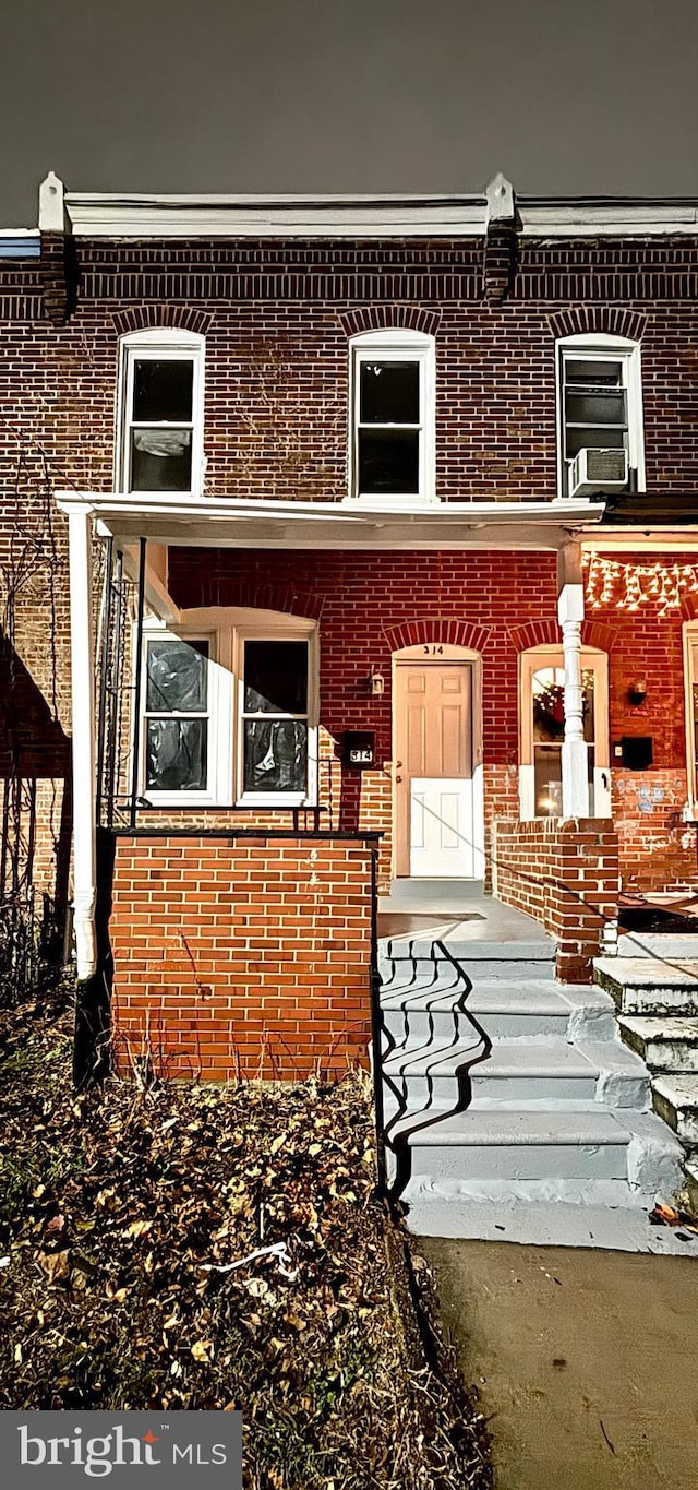 exterior space with cooling unit and brick siding