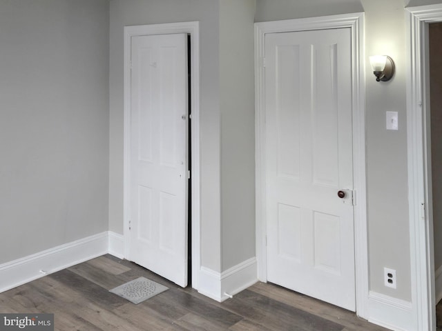 unfurnished bedroom with dark wood-style floors and baseboards