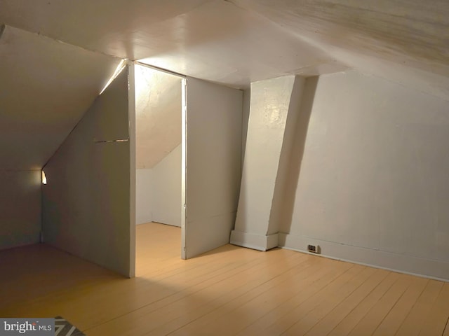 bonus room with hardwood / wood-style flooring and lofted ceiling