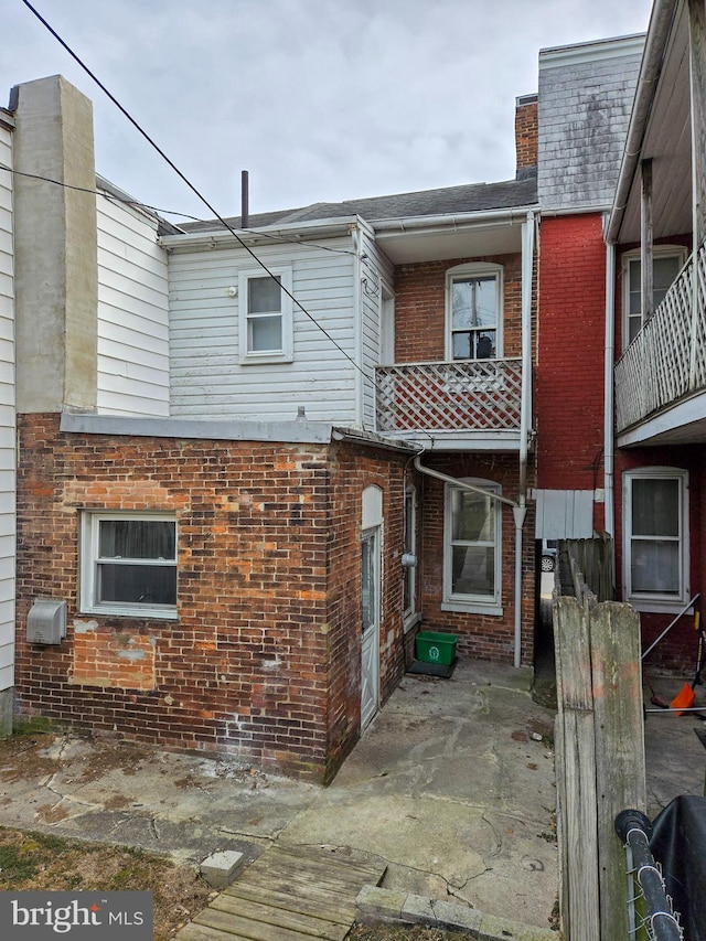 exterior space with a patio and brick siding