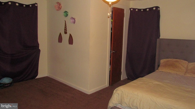 bedroom featuring baseboards and carpet