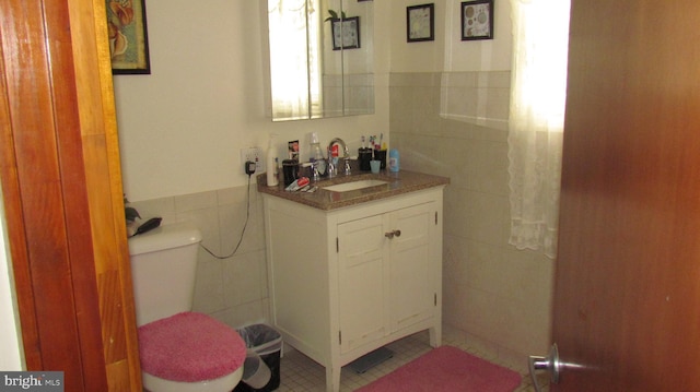 bathroom with vanity, tile walls, toilet, and tile patterned floors