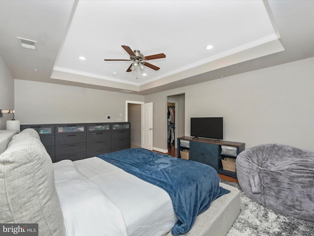 bedroom with recessed lighting, visible vents, a raised ceiling, and crown molding