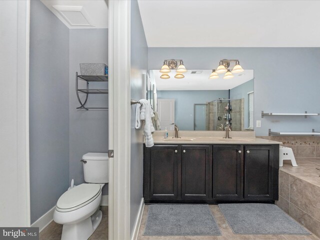 bathroom featuring visible vents, toilet, double vanity, a stall shower, and a sink