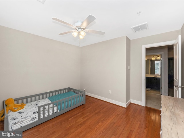 bedroom featuring visible vents, baseboards, wood finished floors, and a ceiling fan