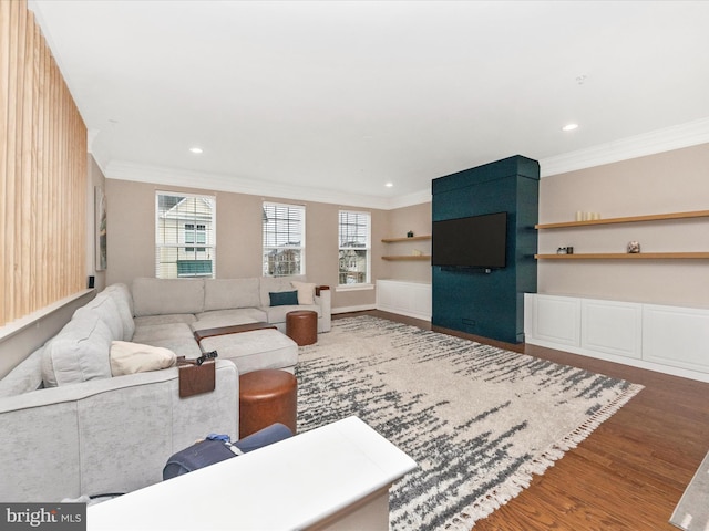 living area with a wealth of natural light, wood finished floors, recessed lighting, and ornamental molding