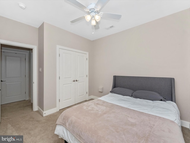 bedroom featuring baseboards, light carpet, visible vents, and ceiling fan