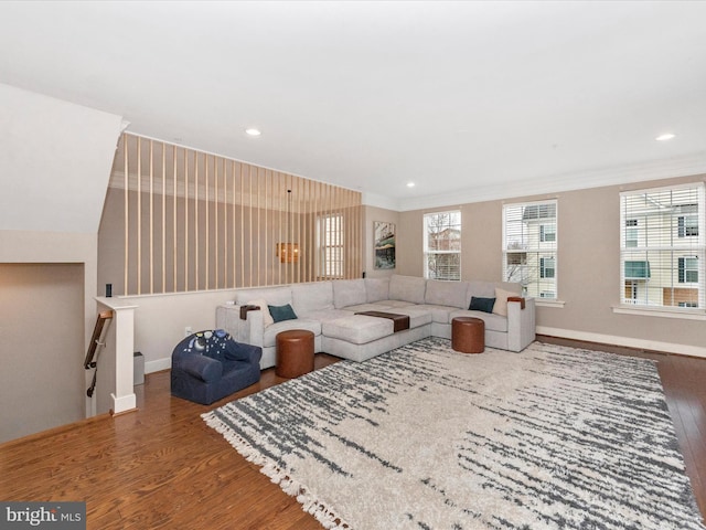 living room with recessed lighting, wood finished floors, baseboards, and ornamental molding