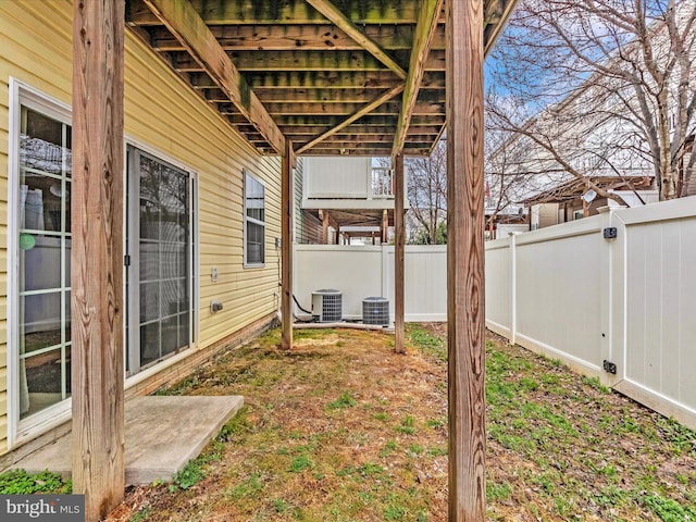 view of yard featuring central AC unit and a fenced backyard