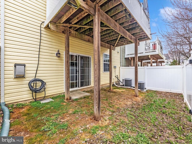 view of yard with central air condition unit and fence