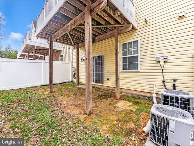 view of yard with central AC unit and fence