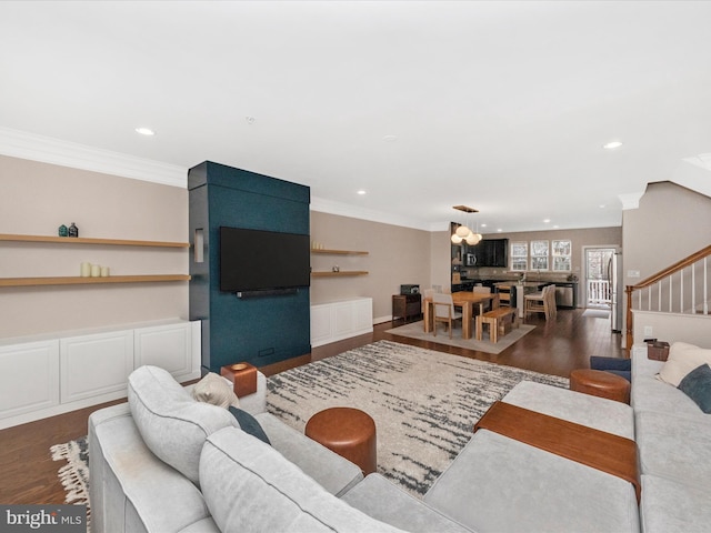 living room with recessed lighting, stairs, crown molding, and wood finished floors