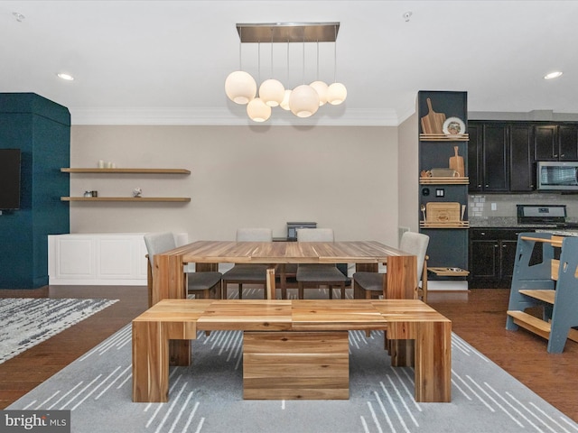 dining space featuring recessed lighting, wood finished floors, a chandelier, and ornamental molding