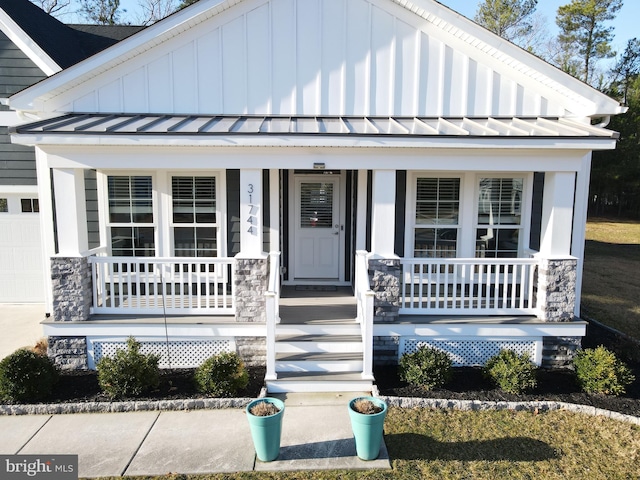 view of front of house featuring covered porch, board and batten siding, metal roof, and a standing seam roof