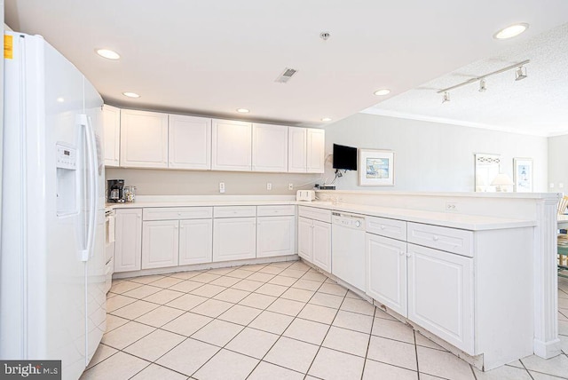 kitchen with white appliances, visible vents, a peninsula, light countertops, and white cabinetry