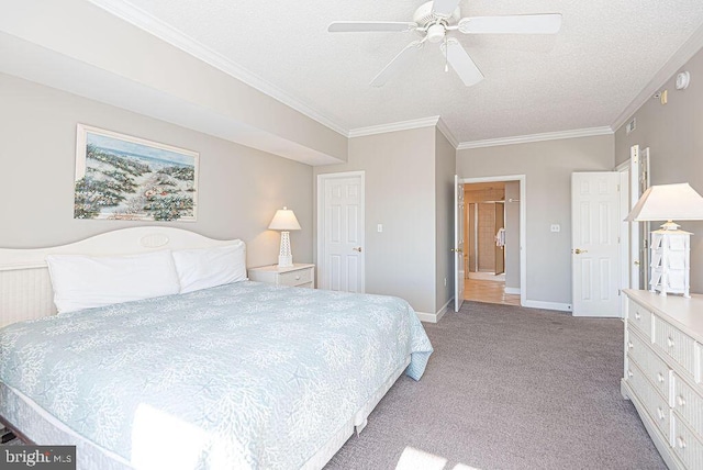 bedroom featuring light colored carpet, a textured ceiling, crown molding, and baseboards