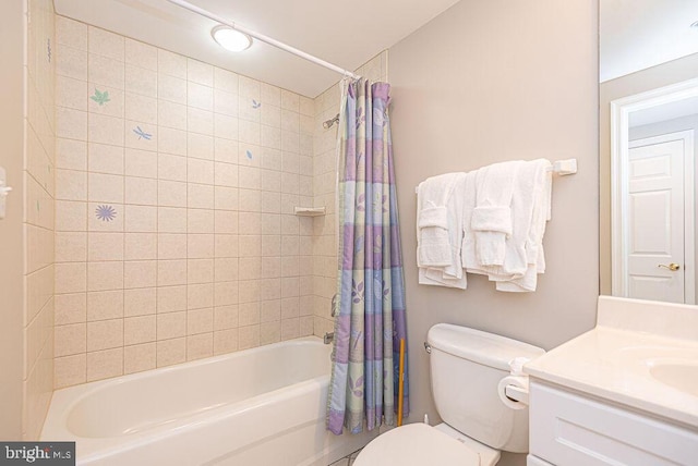 bathroom with vanity, toilet, and shower / tub combo with curtain