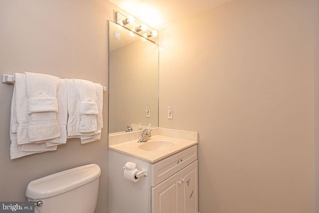 bathroom with toilet and vanity