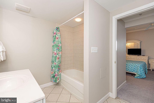 full bathroom with a sink, baseboards, shower / tub combo with curtain, and tile patterned flooring