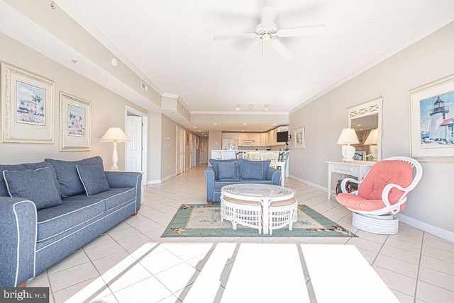 living area featuring light tile patterned floors, baseboards, ceiling fan, and crown molding