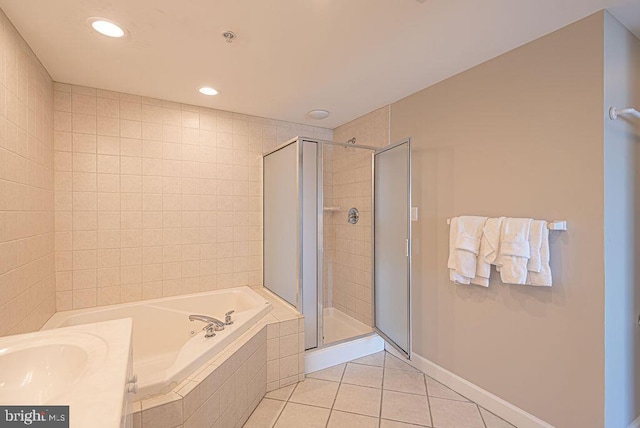 full bath featuring a garden tub, a sink, recessed lighting, a shower stall, and tile patterned flooring