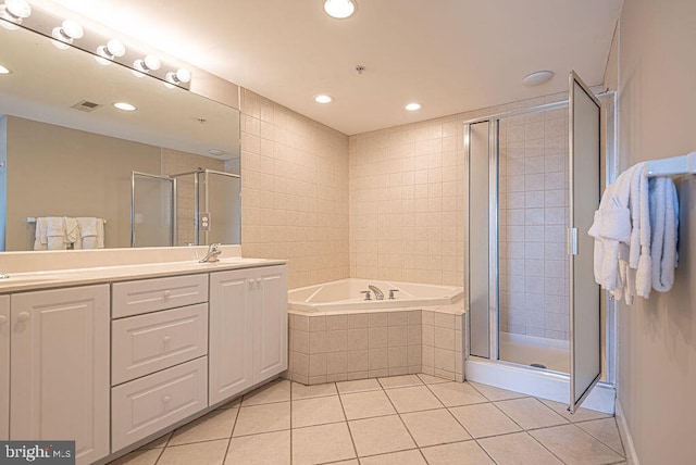 bathroom featuring visible vents, double vanity, a shower stall, tile patterned floors, and a bath