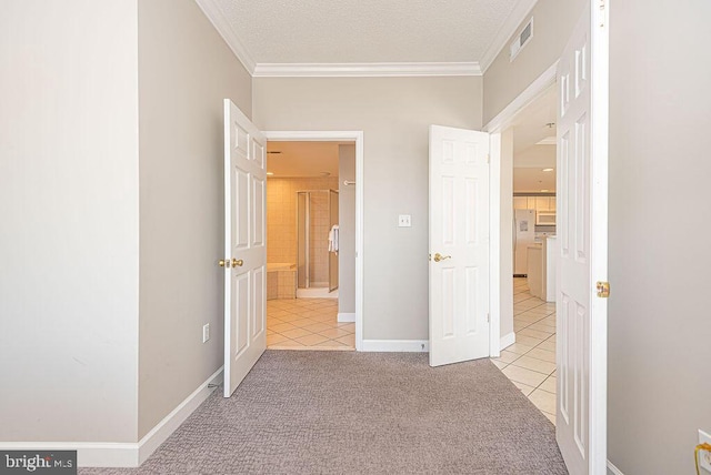 unfurnished bedroom with a textured ceiling, visible vents, freestanding refrigerator, and ornamental molding