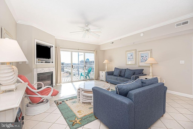 living area featuring ornamental molding, visible vents, and a premium fireplace